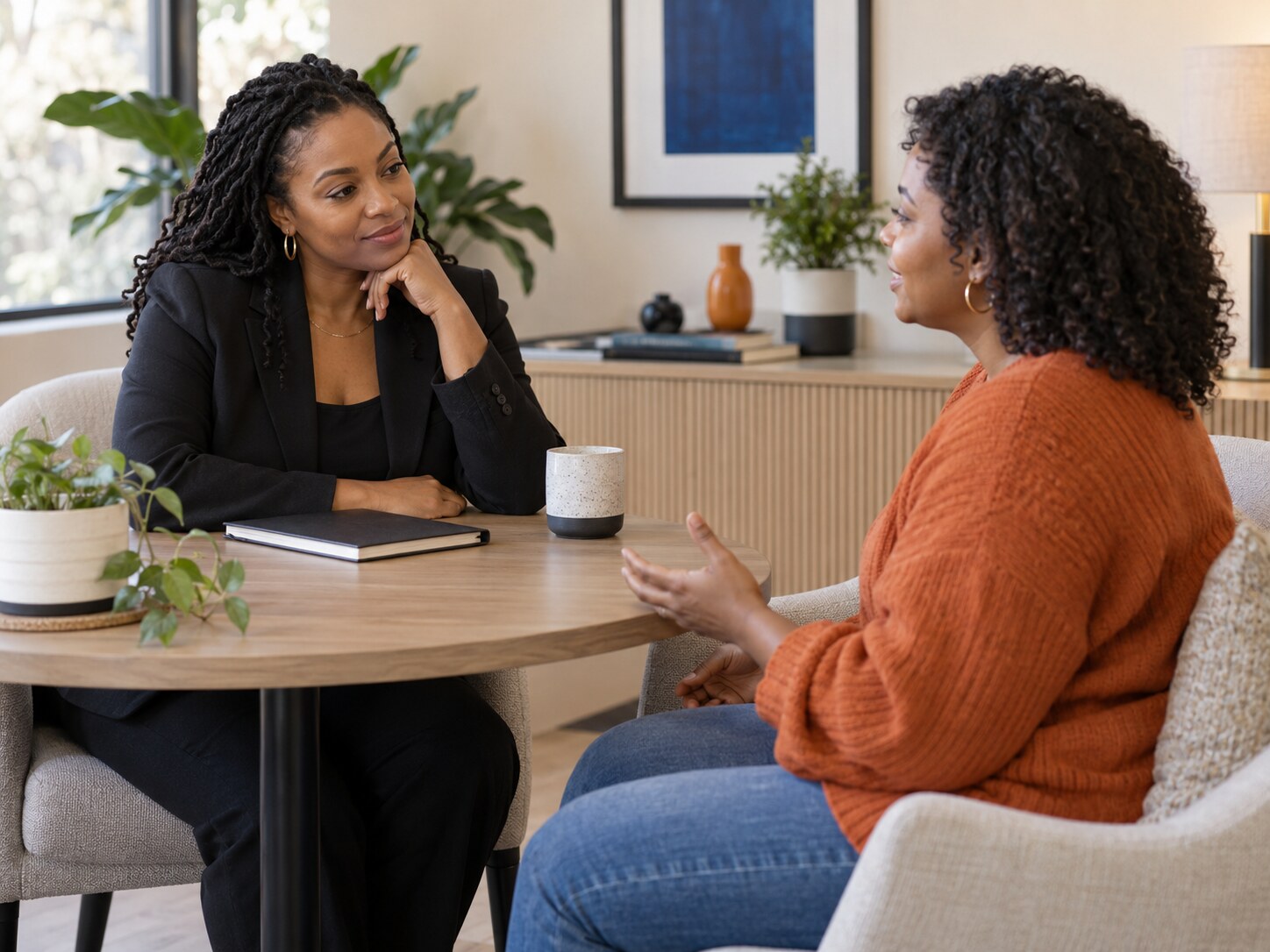 A Black woman having a private, respectful wellness consultation with a Black professional